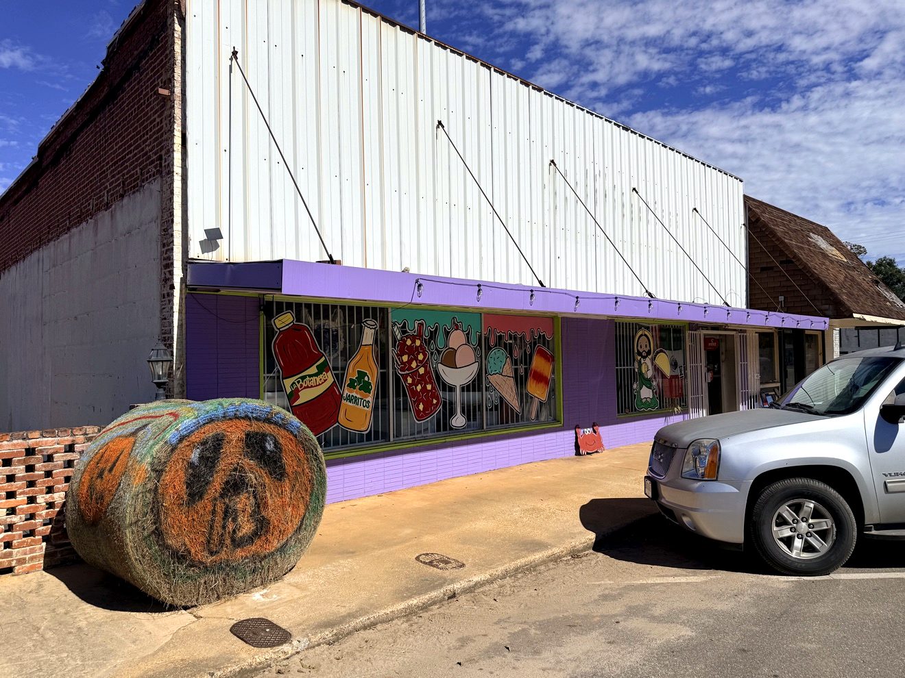A downtown Ariton storefront painted with a colorful food mural